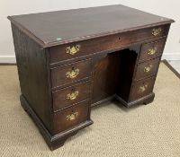 A late George III oak desk, the plain to
