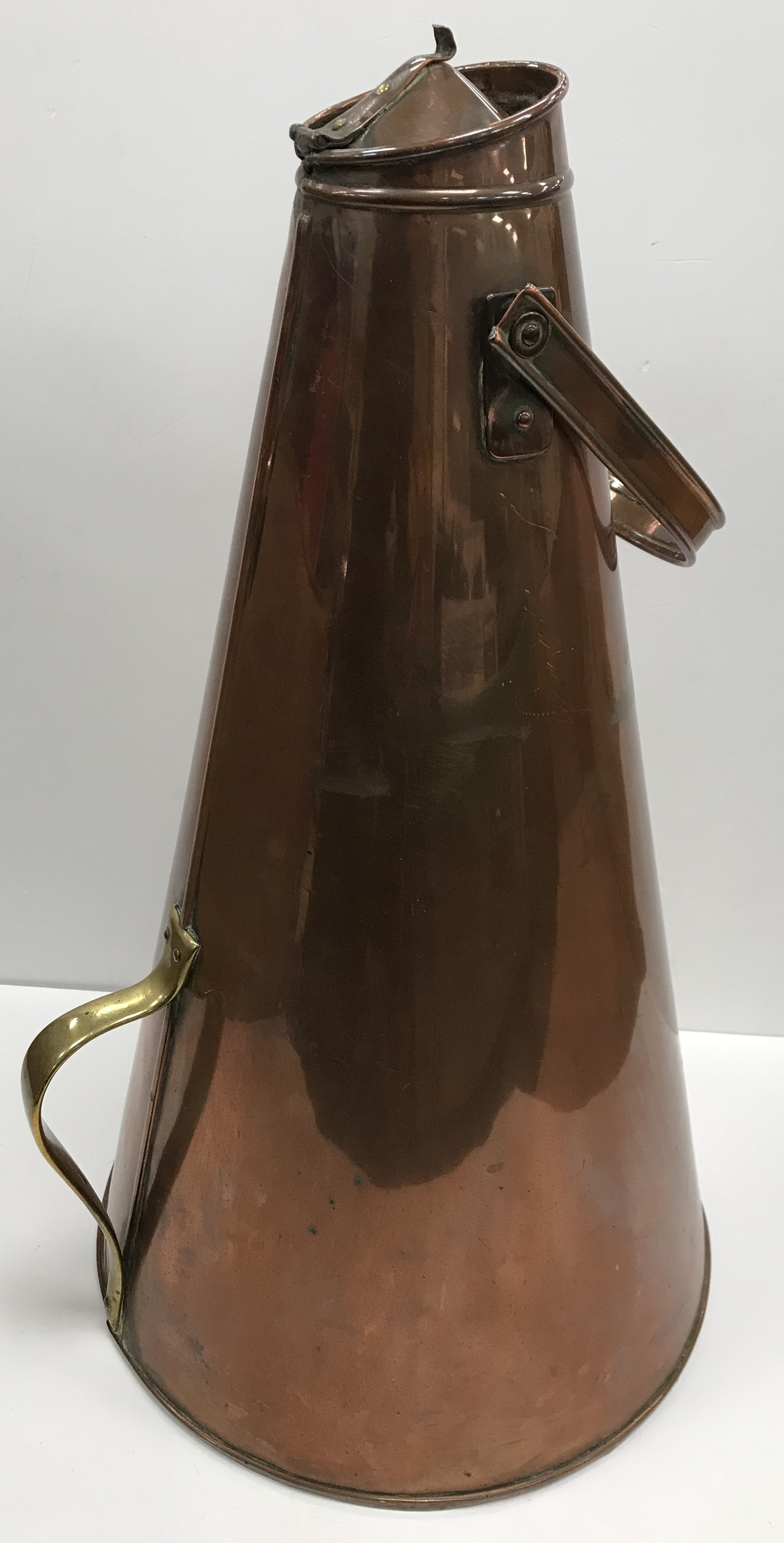 A large copper and brass conical contain
