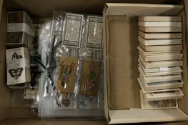 A collection of various cigarette cards,