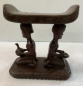 An African carved hardwood head rest or