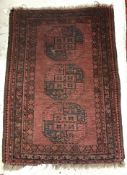 An Afghan rug, the central panel set wit