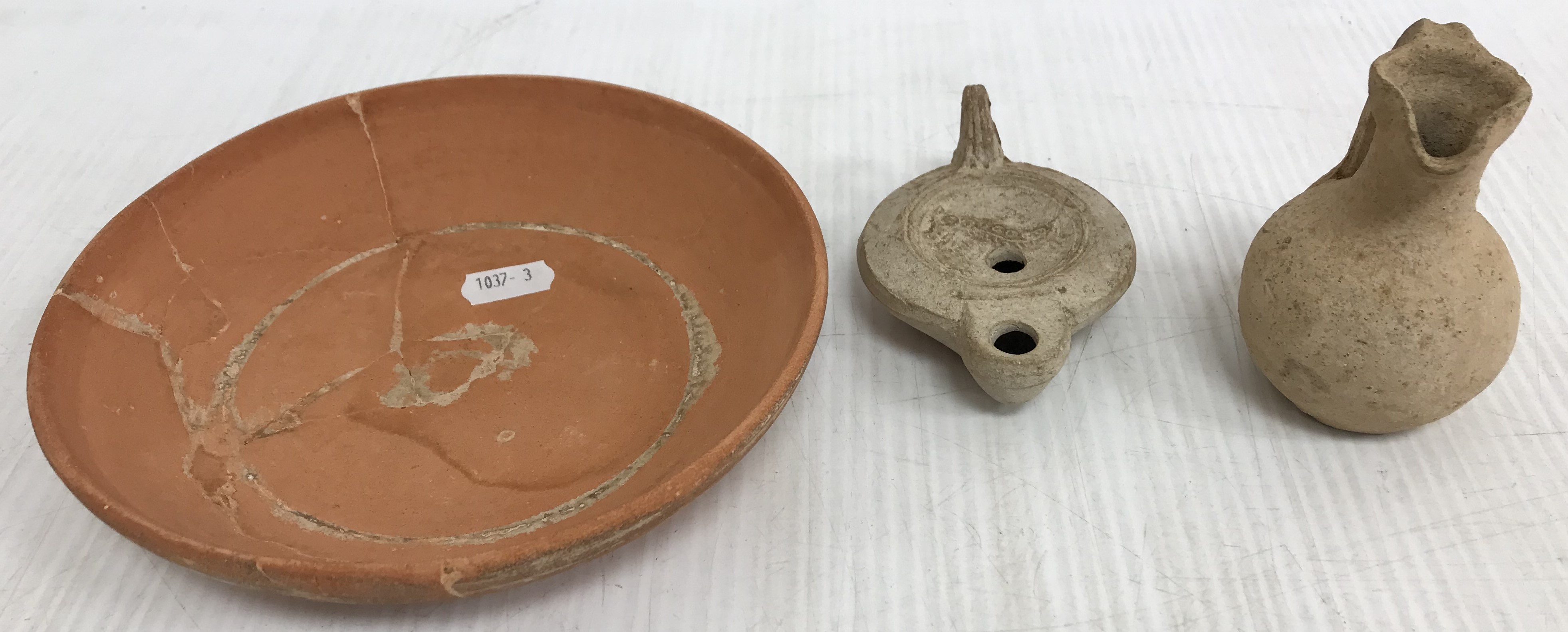 A Roman style pottery oil lamp with serp