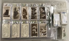 A collection of various cigarette cards,