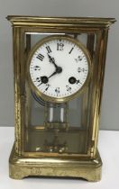 A brass cased mantle clock of rectangular form,