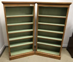A pair of walnut open bookcases in the G