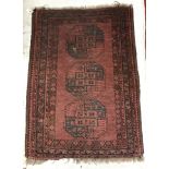 An Afghan rug, the central panel set wit