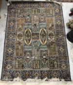 A silk rug, the central panel set with t