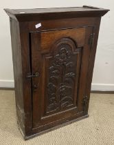 A 19th Century oak cupboard, the canted