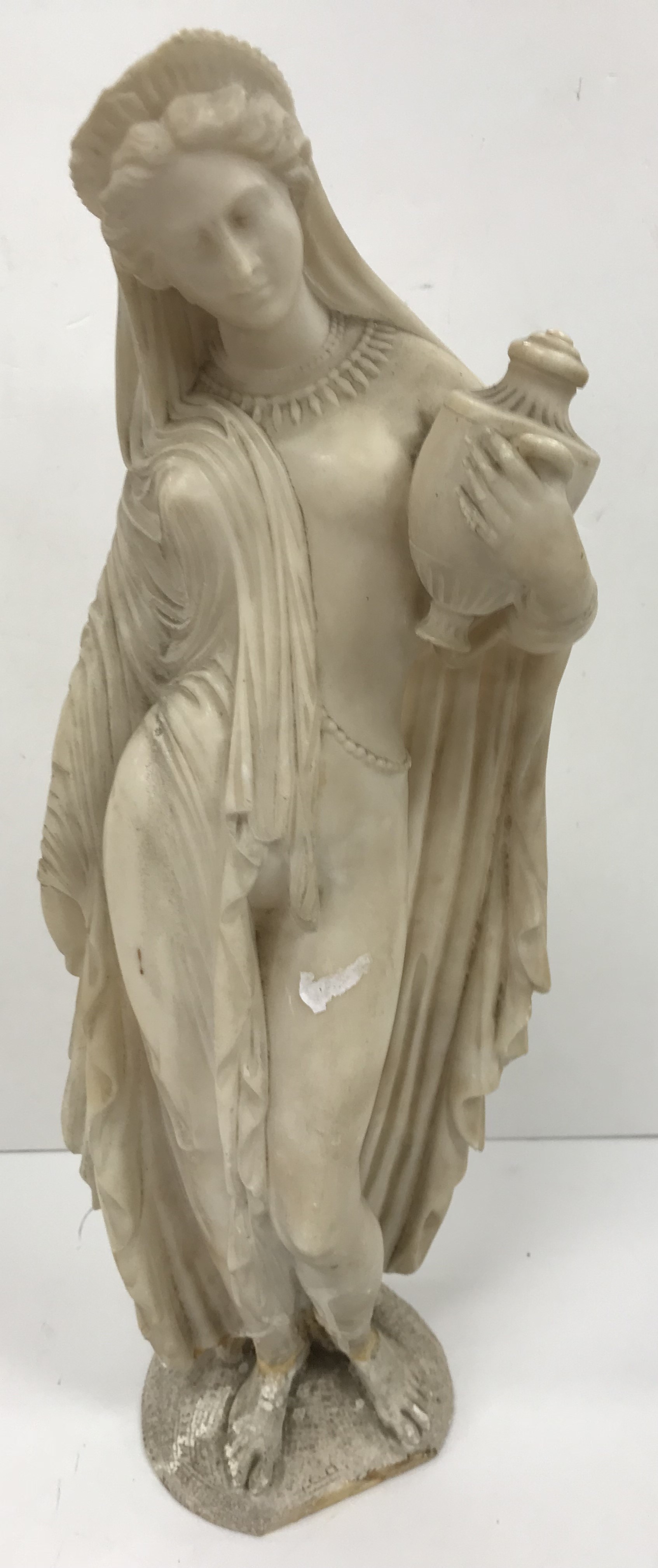 A carved white marble figure of "Phryne'