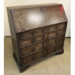 An early 19th Century oak bureau, the pl