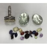 A bag of loose cut gemstones to include