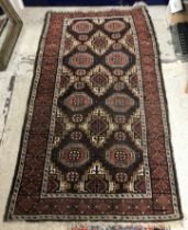 A Belouch rug, the central panel set wit