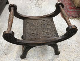 A late Victorian carved oak stool in the