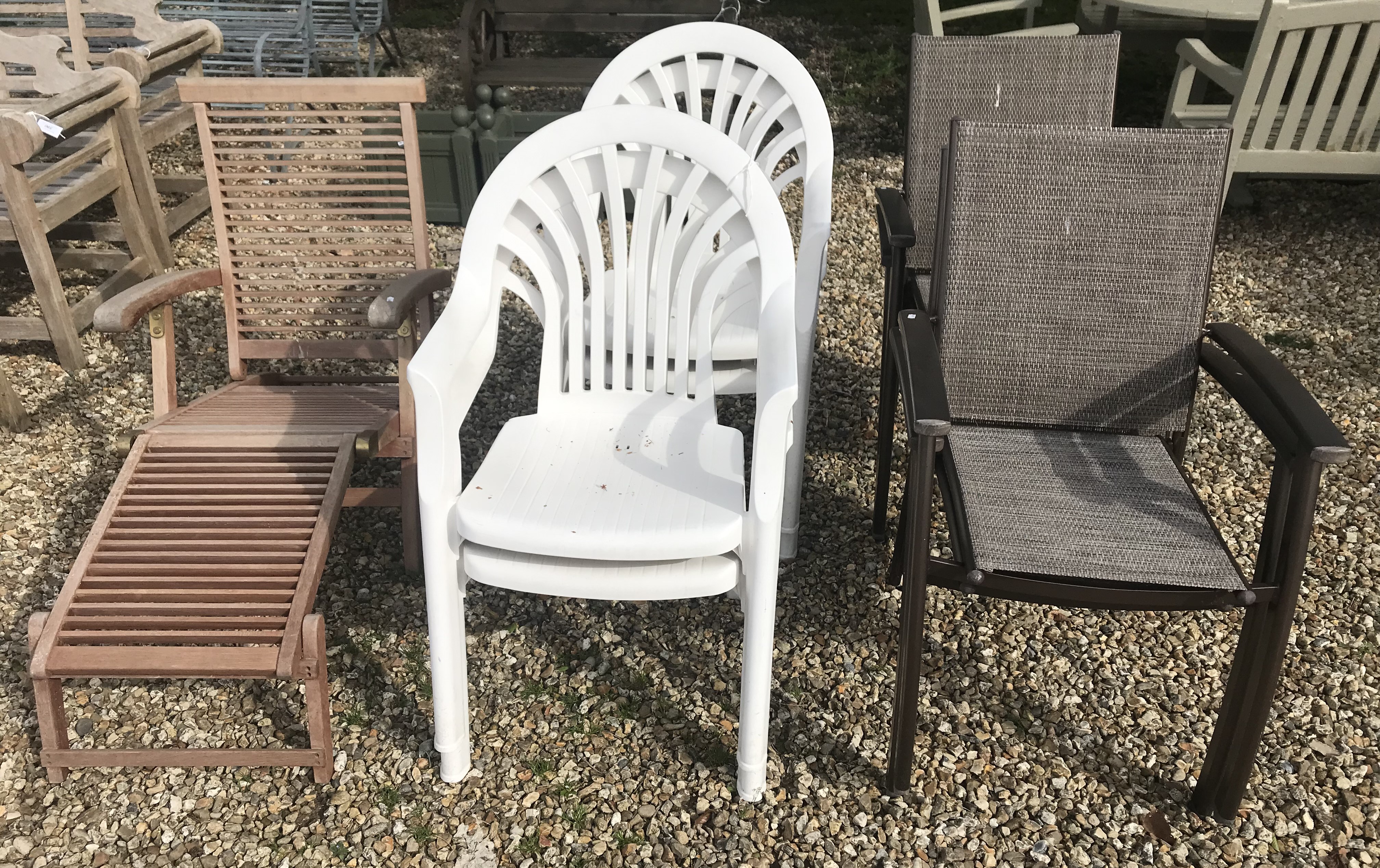 A slatted teak steamer chair, four white