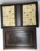 A vintage bone and bamboo and pen work decorated mah-jong set in a wire inlaid teak box with two