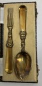 A George IV silver gilt fork and spoon with floral and foliate cast decoration and faceted amber