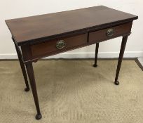 A mahogany two drawer serving table in the Georgian manner raised on turned tapering legs to pad