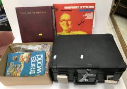 A box and contents of three albums conta