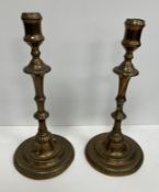 A pair of 18th Century bell metal candle