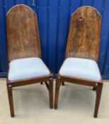 A pair of modern teak high back dining c