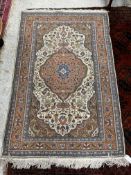 A Persian rug, the central panel set wit