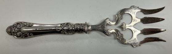 A sterling silver handled bread fork wit