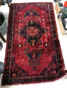 A Persian rug, the central panel set wit