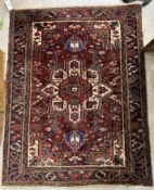 A Persian rug, the central panel set wit