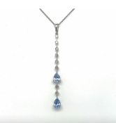 An 18ct white gold diamond and sapphire pendant - An 18ct white gold pendant of linear form
