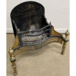 A 19th Century brass and iron serpentine fronted fire basket with sunburst decorated back,