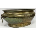 A 19th Century Dutch brass wine cooler of elongated oval form, the main body with embossed armorial,