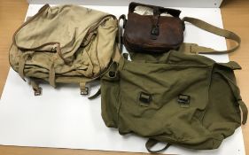 A leather cartridge bag with canvas stra