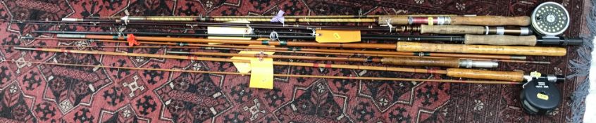 A collection of six various rods including a two piece split cane with Shakespeare Alpha 2891 reel,