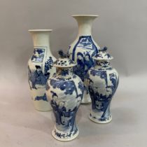 A pair of Chinese blue and white vases of baluster form having associated covers the bodies