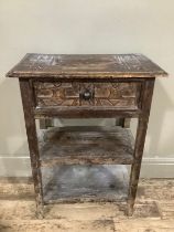 A fruitwood side table with one drawer above two tiers and having indigenous style carvings, 55cm