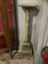 An onyx and gilt metal torchere with square top above column on plinth base, 27cm wide x 107cm high