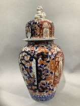 A Japanese Imari vase and cover, the fluted body painted in the typical Imari palette, having a