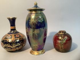 A Carlton Ware lustre Stork and Bamboo vase and cover in midnight blue with gilding on pedestal