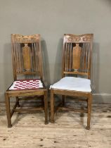 A pair of arts and crafts oak single chairs having a splat and railed back and on square framing
