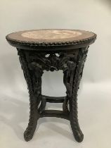 A carved Chinese hardwood jardiniere, the top inset with marble, 47cm high