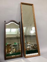 A teak framed mirror and another