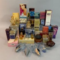 A quantity of vintage and modern perfume bottles including a sealed Hermes Caleche, YSL Paris, Fendi