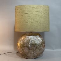 A faux mother-of-pearl table lamp of rounded and flattened form with oblong silk shade, 80cm high