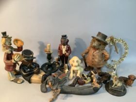 A resin figure of a hedghog in suit with hat, a ceramic model of a conductor asleep with pipe, a