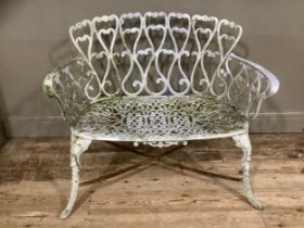 A cast iron white painted ornate pierced garden bench