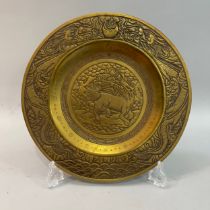 A Chinese polished bronze charger, engraved to the centre with a dragon within a geometric band,