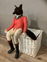 A large stuffed figure of a huntsman fox together with a white wicker basket