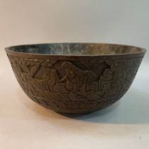 A Chinese bronze ritual or singing bowl, the exterior engraved in relief with figures in a garden,