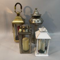 Two chrome storm lanterns, a brass example and another