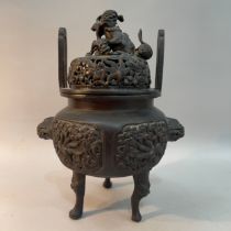 A Japanese bronzed koro incense burner, the cover with two dogs of fo finial above a pierced dome,